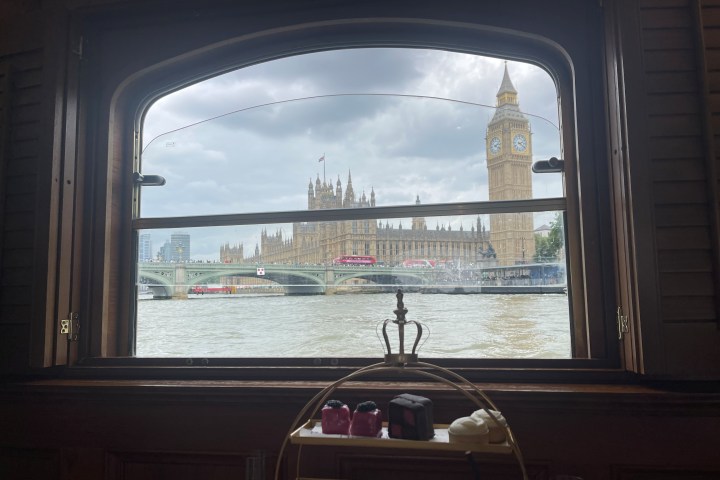 View of Big Ben and Westminster from a boat window with tea service in the foreground.