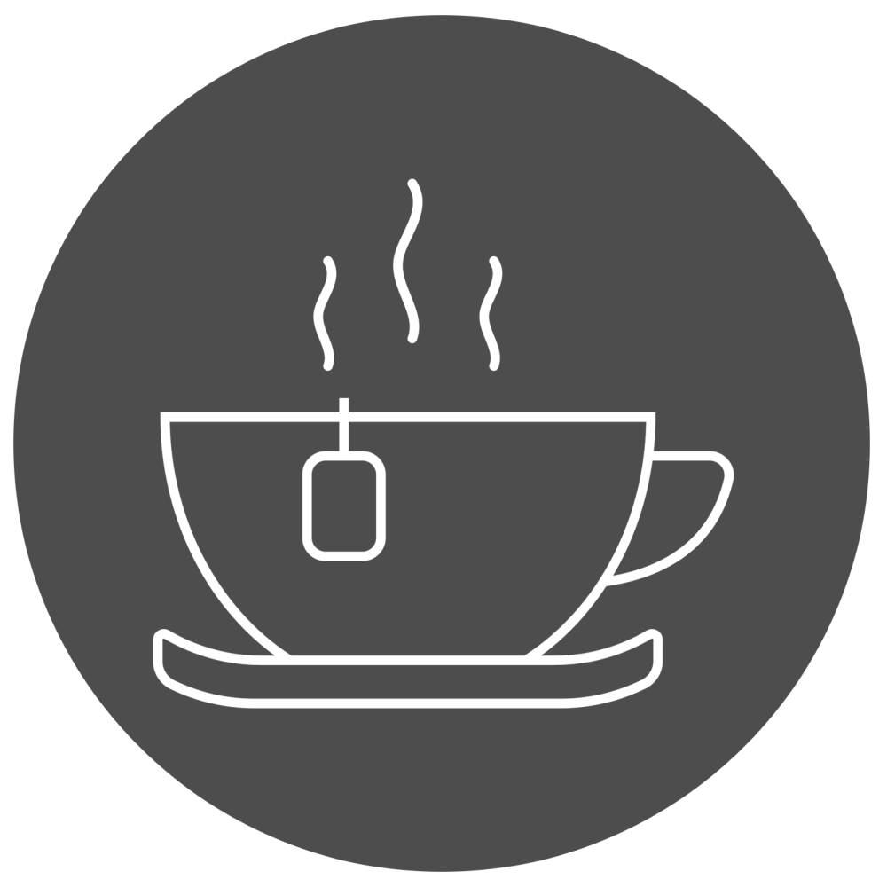 Steaming tea cup with a tea bag on a dark circular background.